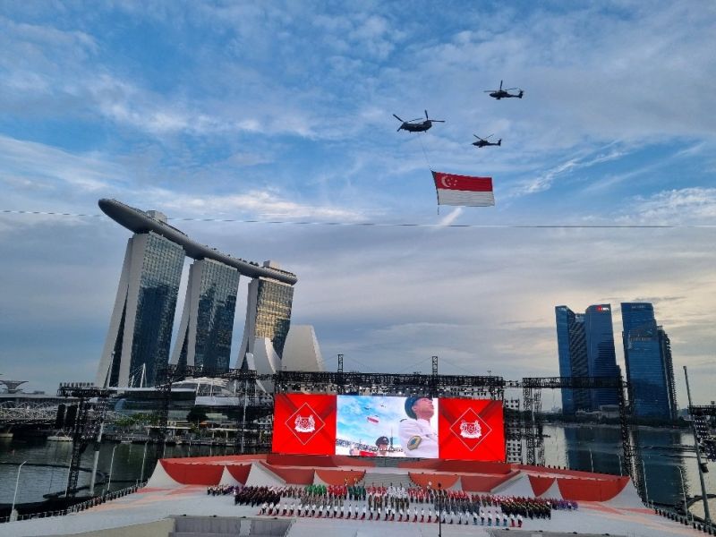 Singapore National Day event at Marina Bay with helicopters carrying the Singapore flag
